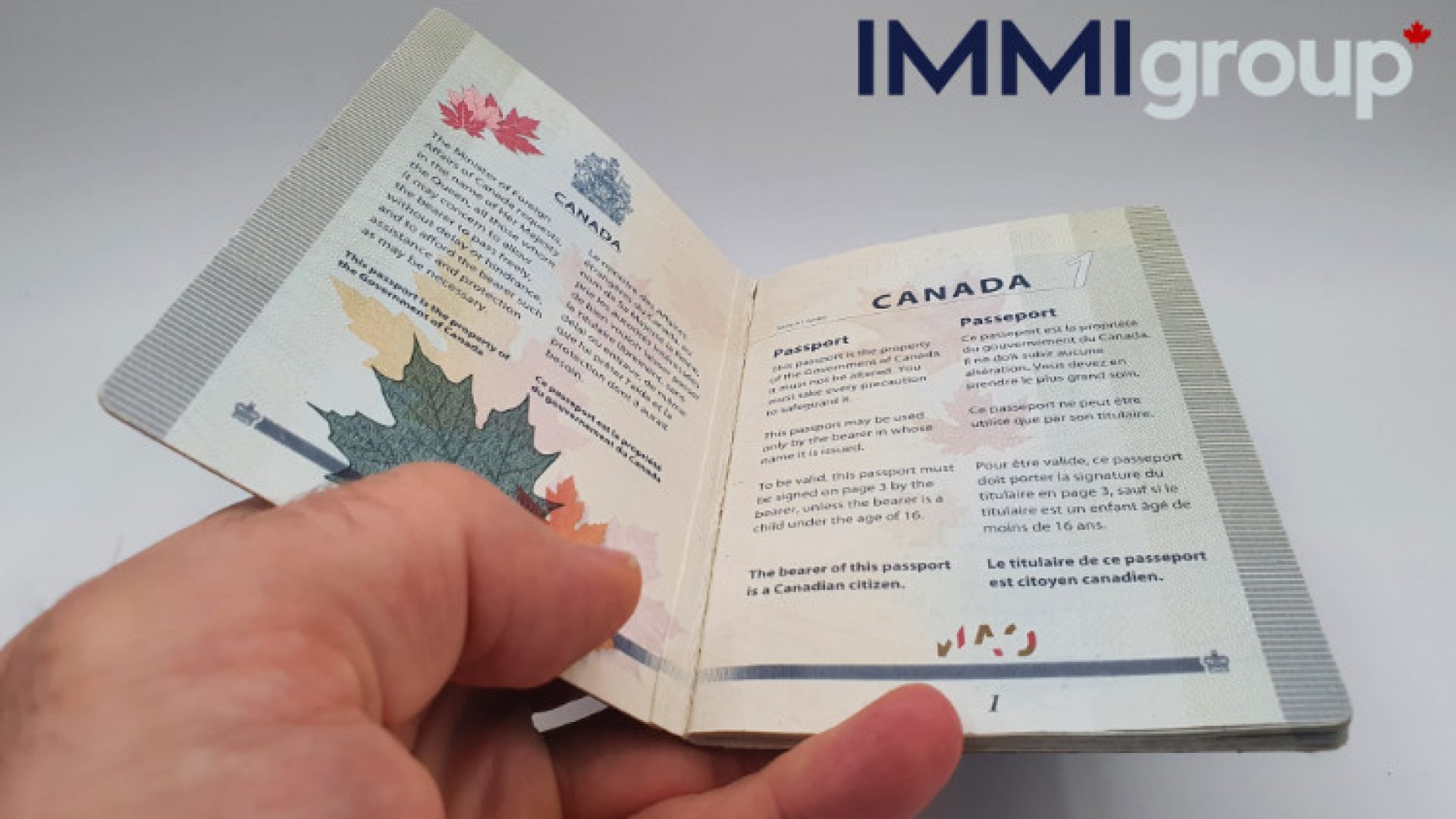 man holding a passport from Canada. Proving citizenship